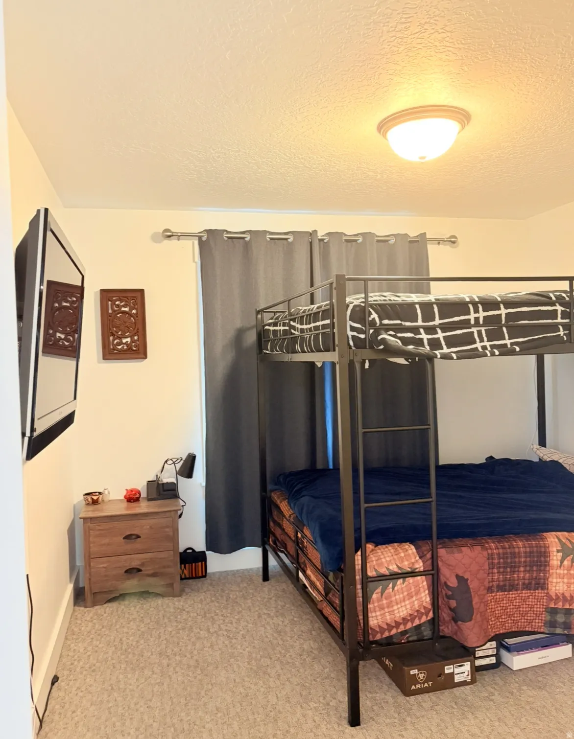 Bedroom featuring a textured ceiling and light colored carpet