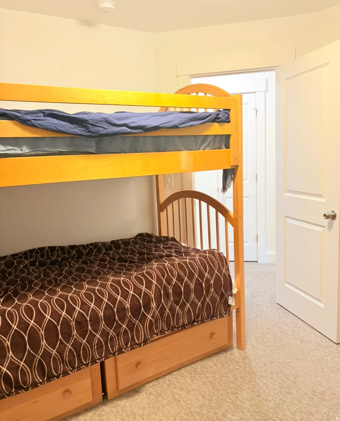 Bedroom featuring light carpet