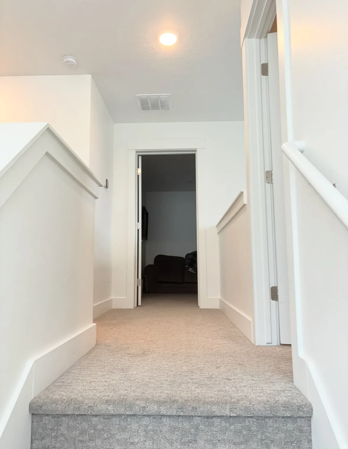 Stairs with carpet flooring and baseboards