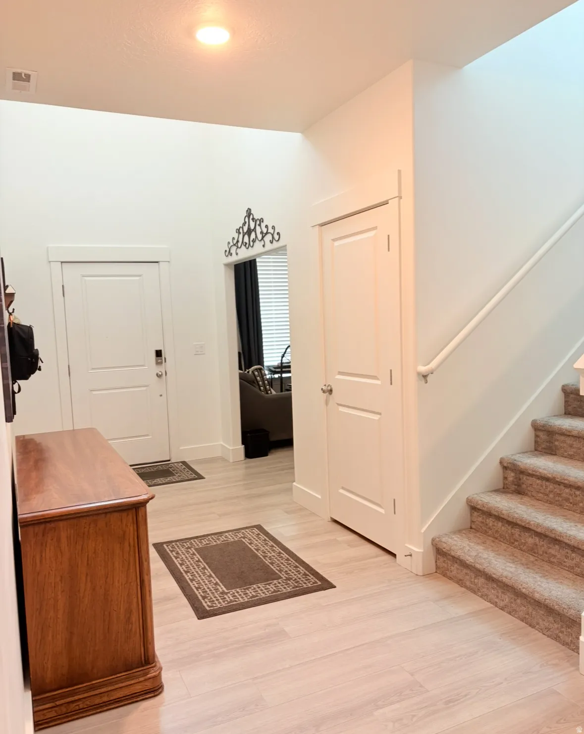 Entrance foyer featuring light wood-type flooring and stairway