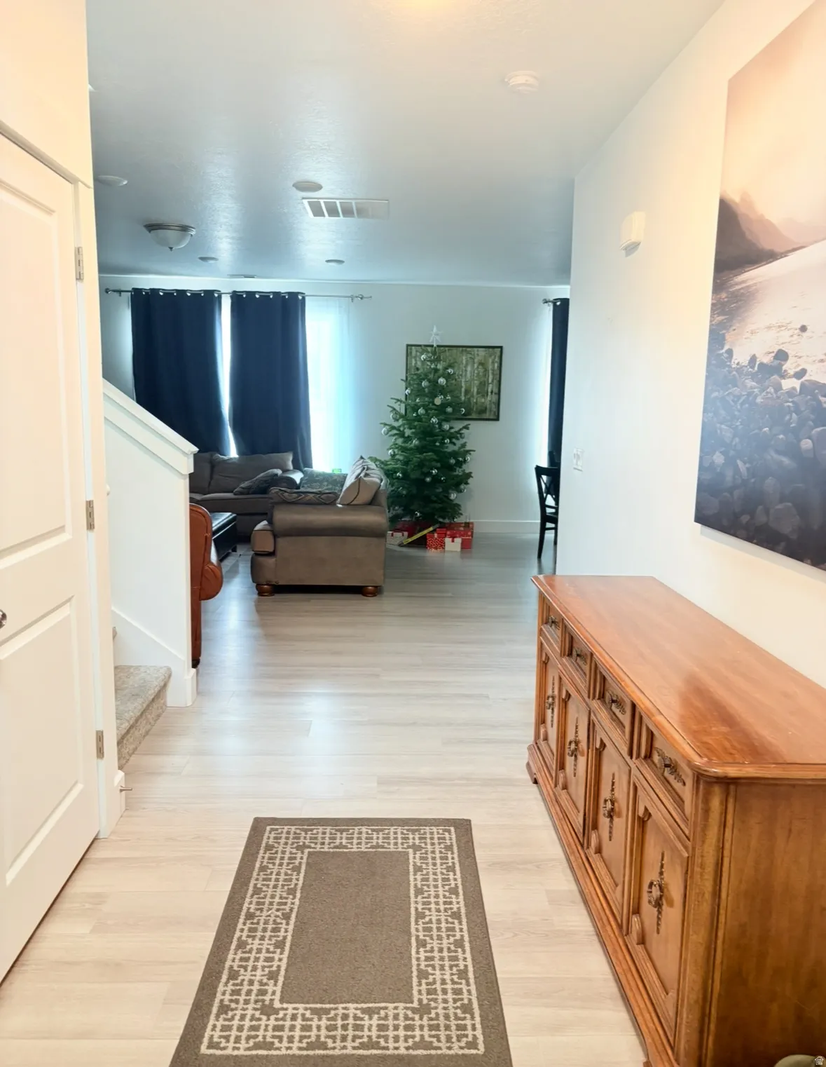 Hallway featuring light wood-style flooring and stairway