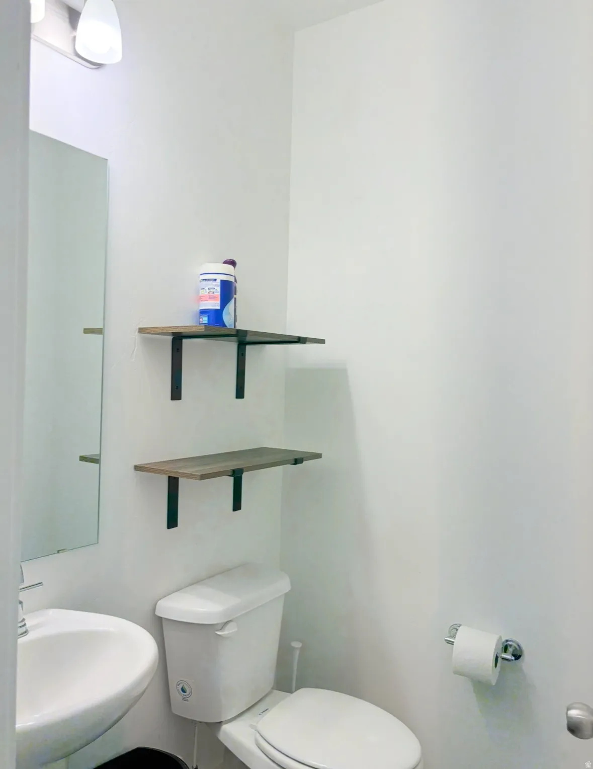 Half bathroom with toilet and a sink