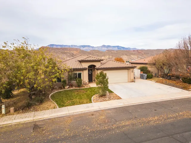 Mediterranean / spanish home with driveway, a mountain view, stucco siding, and a garage
