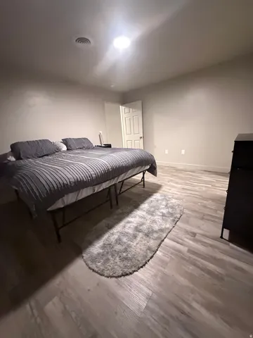 Bedroom featuring light wood-style floors and baseboards