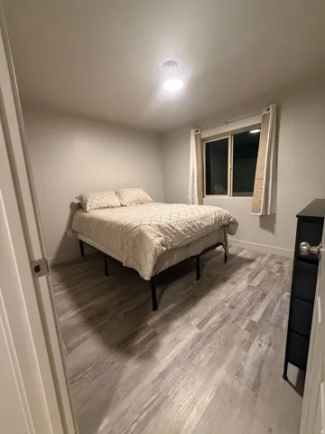 Bedroom featuring light wood-style flooring and baseboards