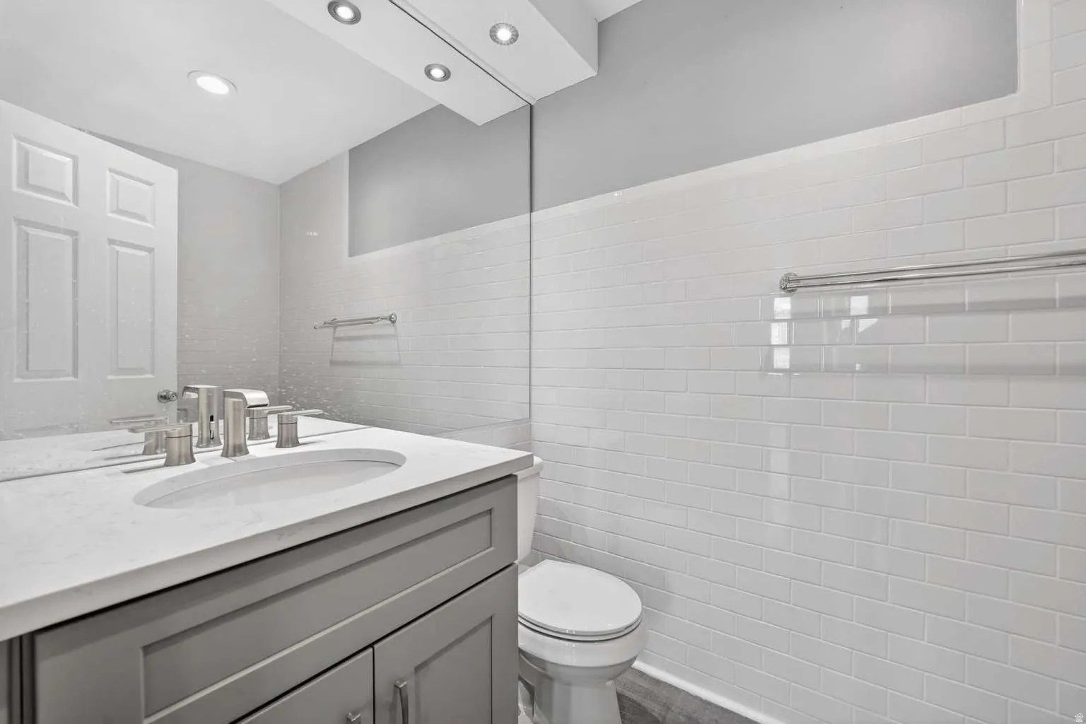 Half bath with vanity and tile walls