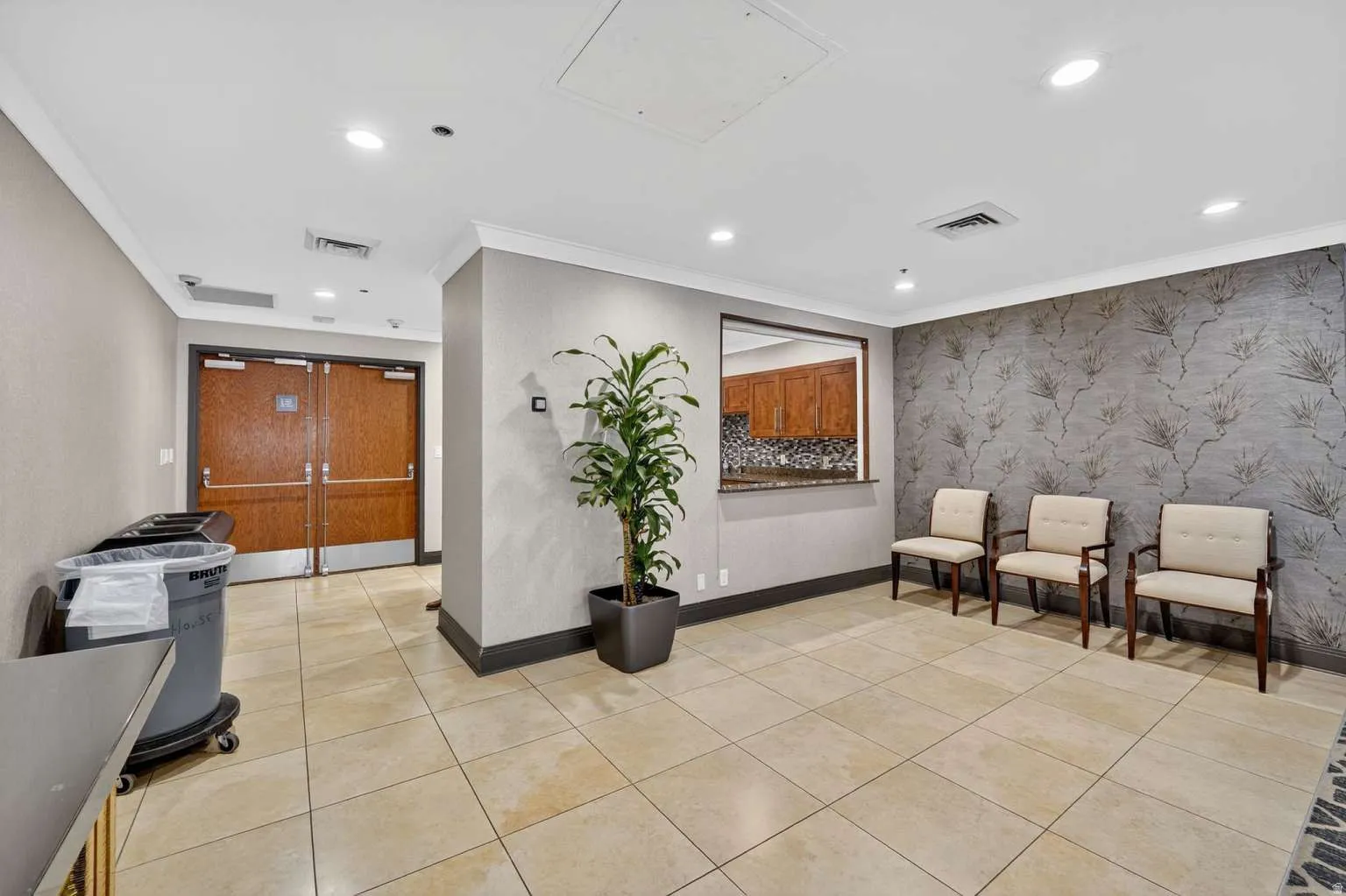 Lobby featuring crown molding, recessed lighting, and wallpapered walls