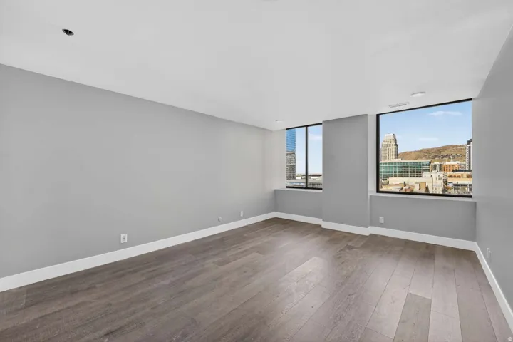 Spare room featuring dark wood finished floors and a view of city
