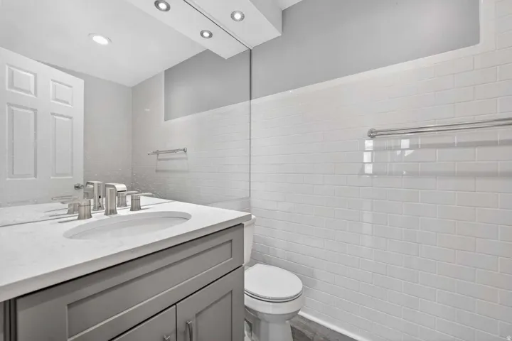 Half bath with vanity and tile walls