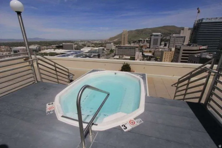 View of pool with patio surround, a city view, and a mountain view