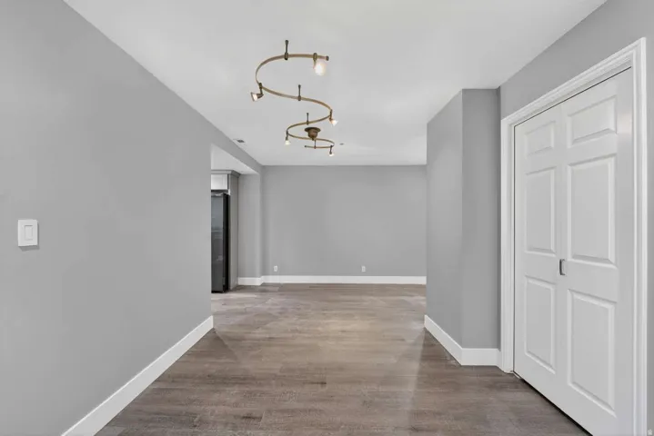 Hall featuring baseboards and light wood-type flooring