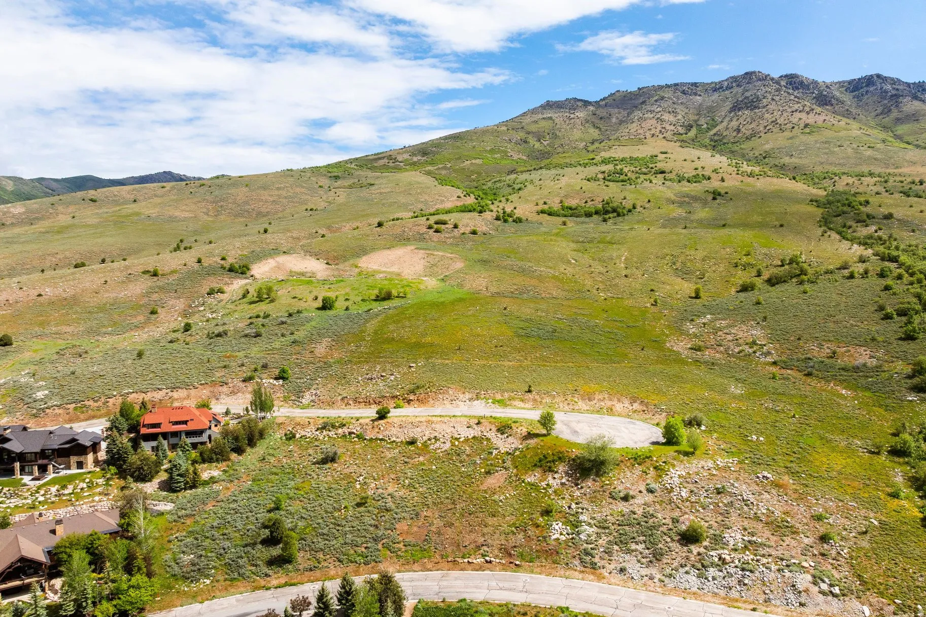 Expansive mountain lot featuring varied terrain and established roads