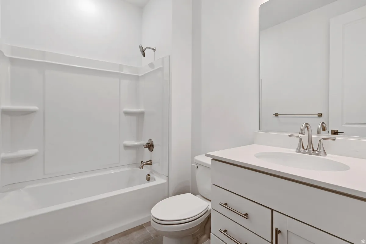 Full bathroom featuring vanity, shower / bathtub combination, and light tile patterned floors