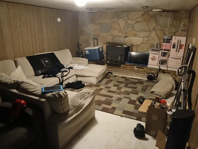 Living room featuring wood walls and concrete floors