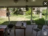 View of patio with a storage shed