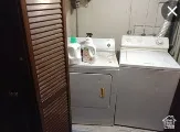 Laundry area featuring washing machine and clothes dryer