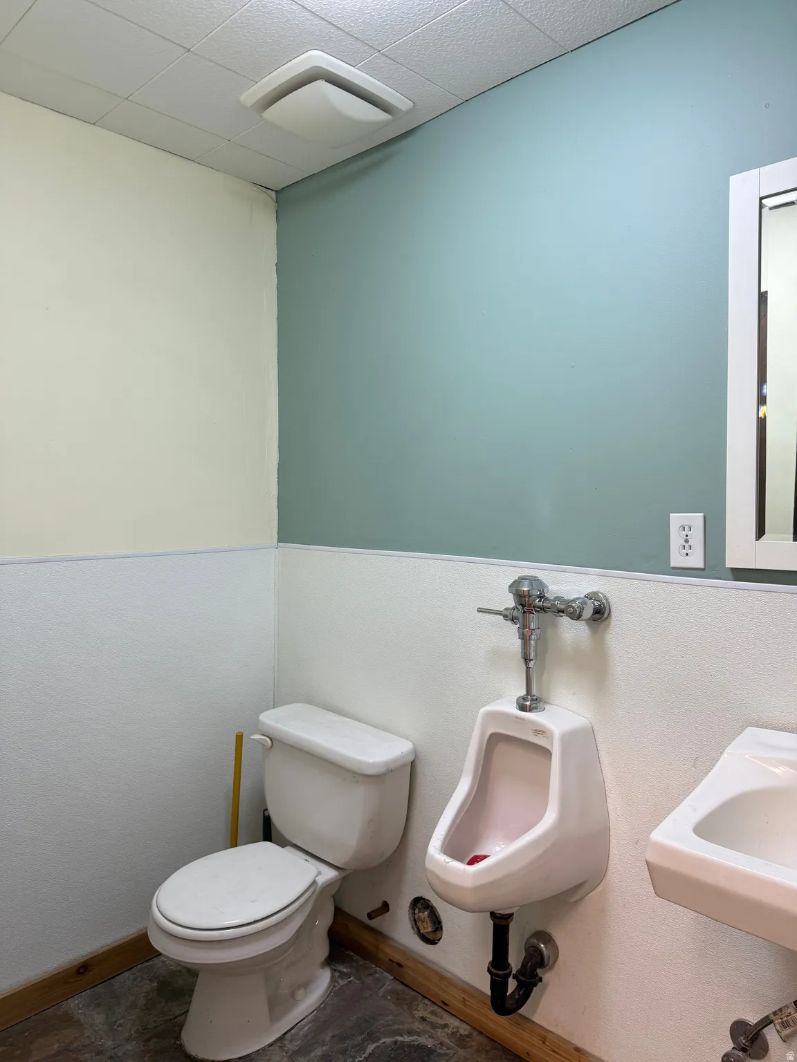 Half bathroom featuring toilet and a paneled ceiling