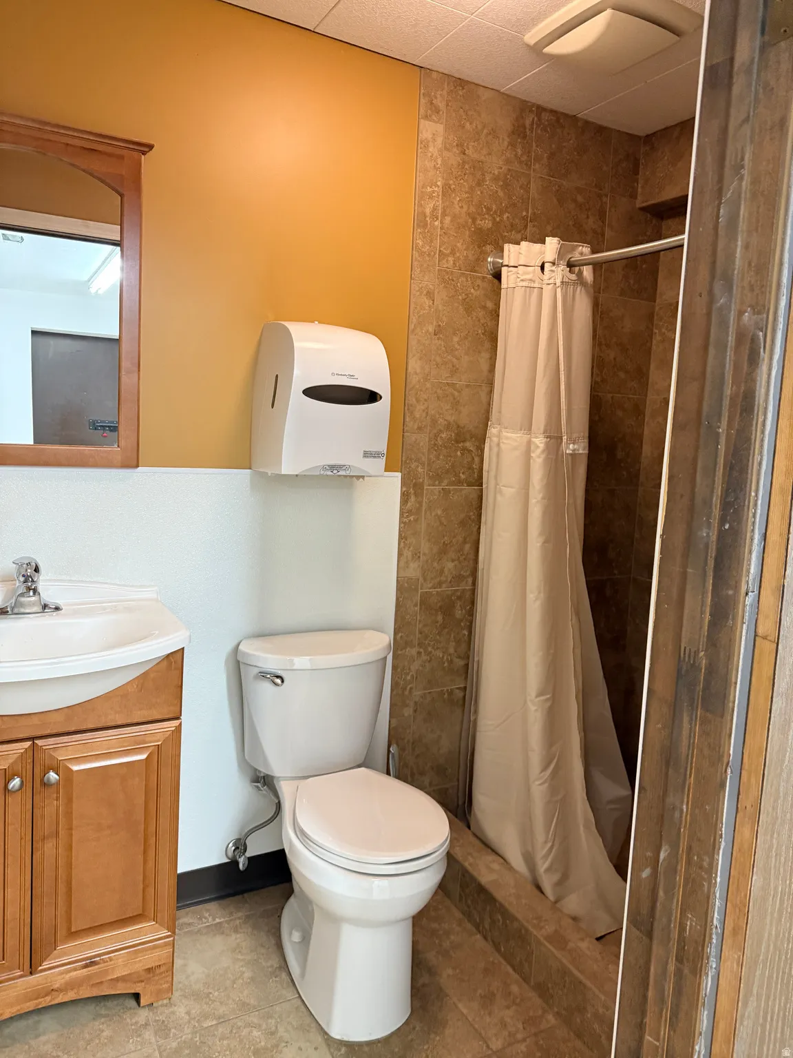 Full bath with a stall shower, vanity, and tile patterned floors