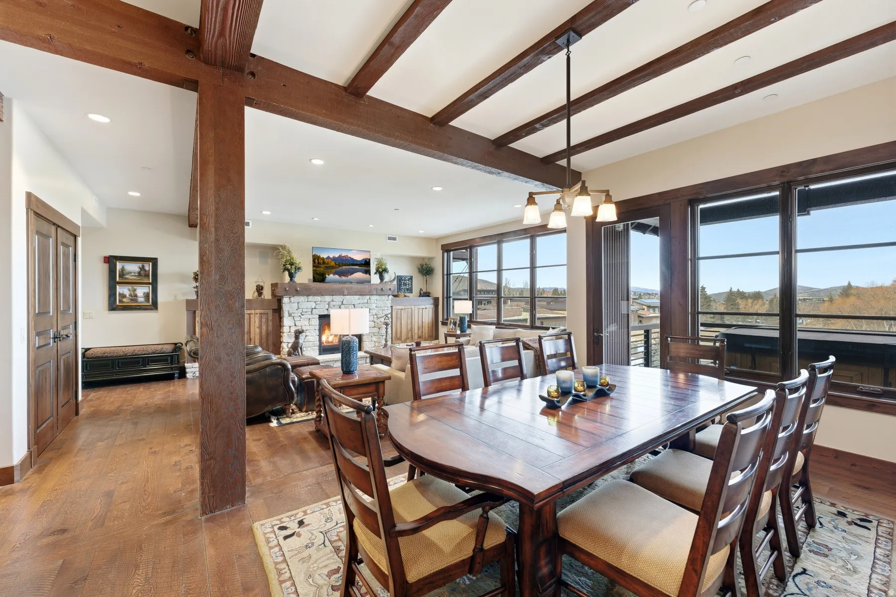 Dining area featuring a fireplace, hardwood / wood-style floors, recessed lighting, and beam ceiling