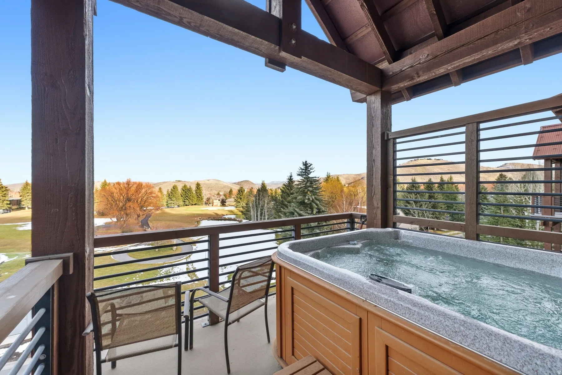Balcony featuring a mountain view and a hot tub