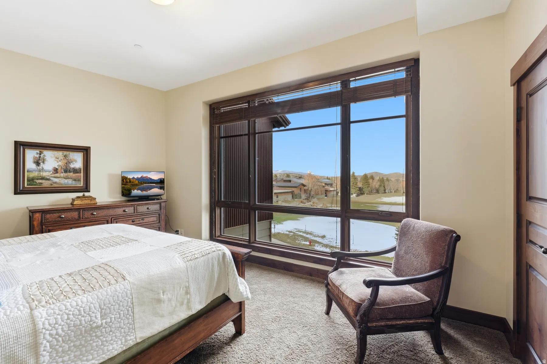 Bedroom featuring light carpet