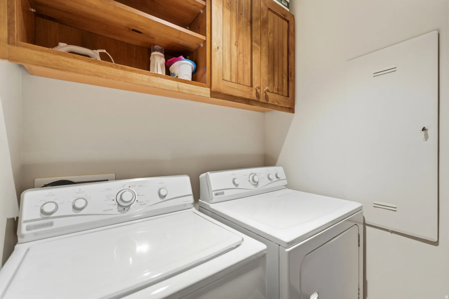 Laundry room featuring cabinet space and separate washer and dryer