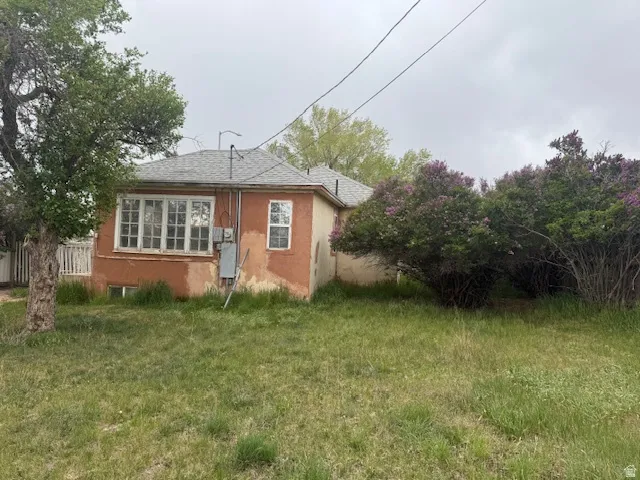 Rear view of property featuring stucco siding