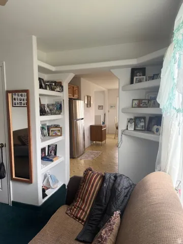 Living area featuring built in shelves