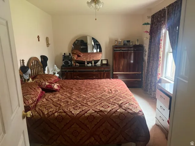Bedroom featuring light colored carpet and ceiling fan