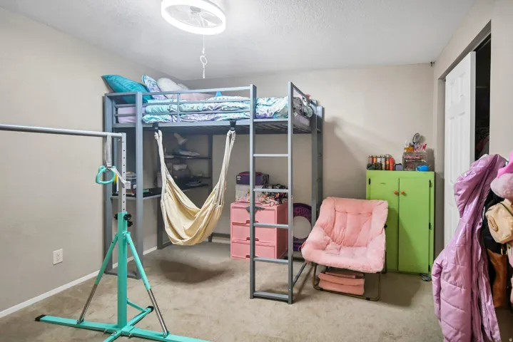 Bedroom with carpet and a textured ceiling