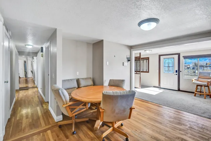 Dining space featuring a textured ceiling and wood-type flooring