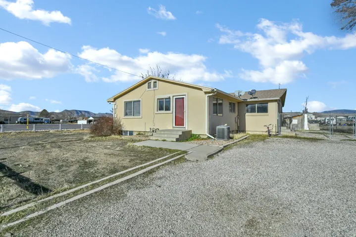 View of front of property with stucco siding and a mountain view