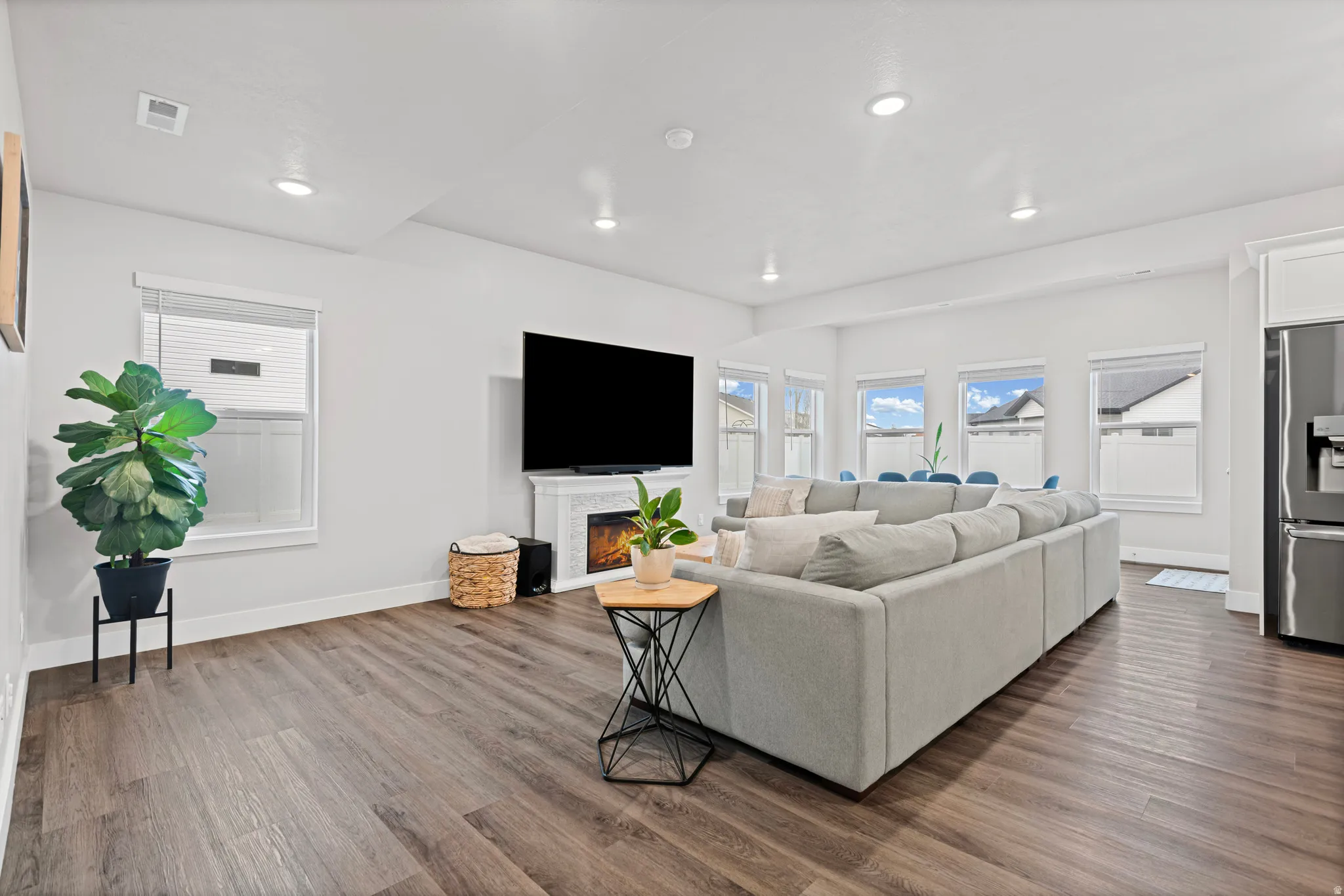 Living room featuring a lit fireplace and dark wood finished floors