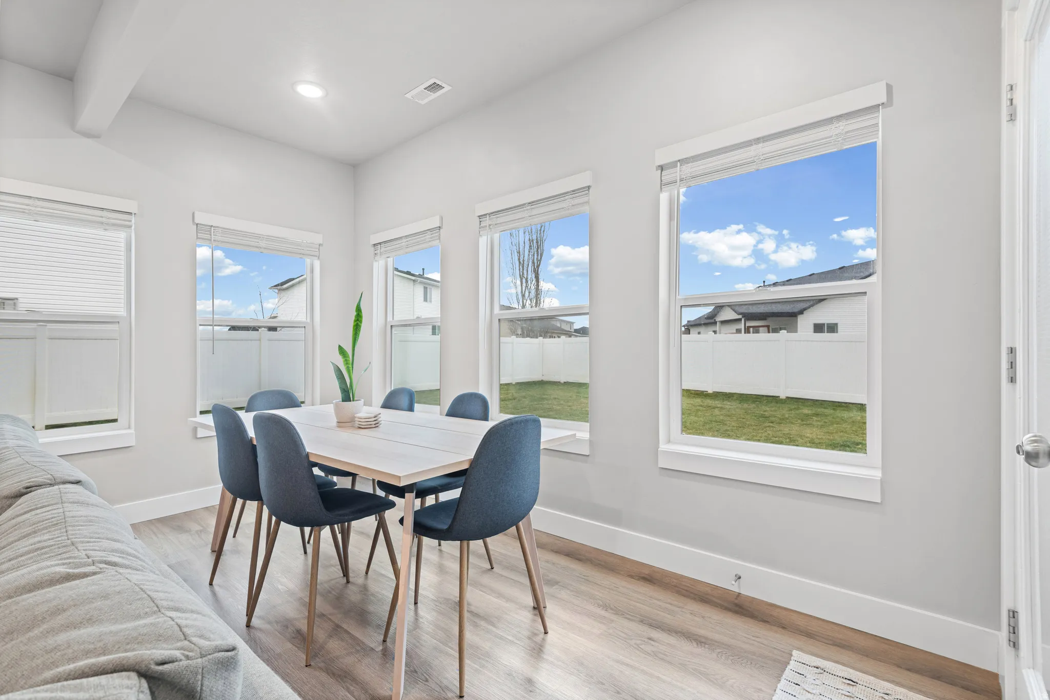 Dining space featuring light wood-style flooring, healthy amount of natural light, and recessed lighting