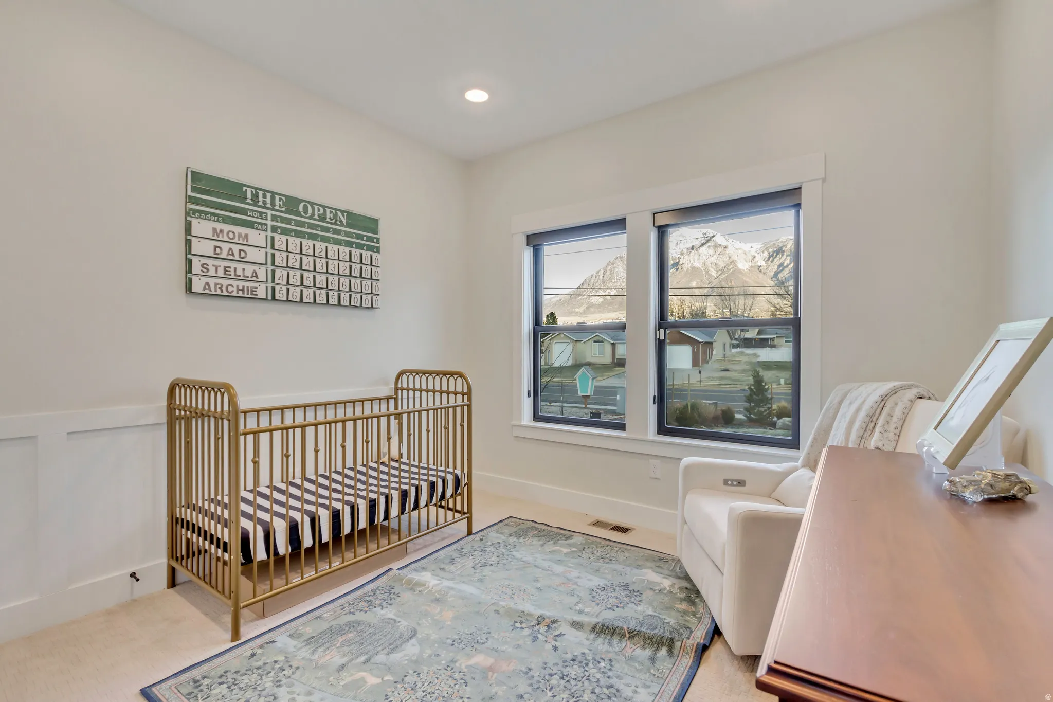 Bedroom with light carpet, recessed lighting, and wainscoting