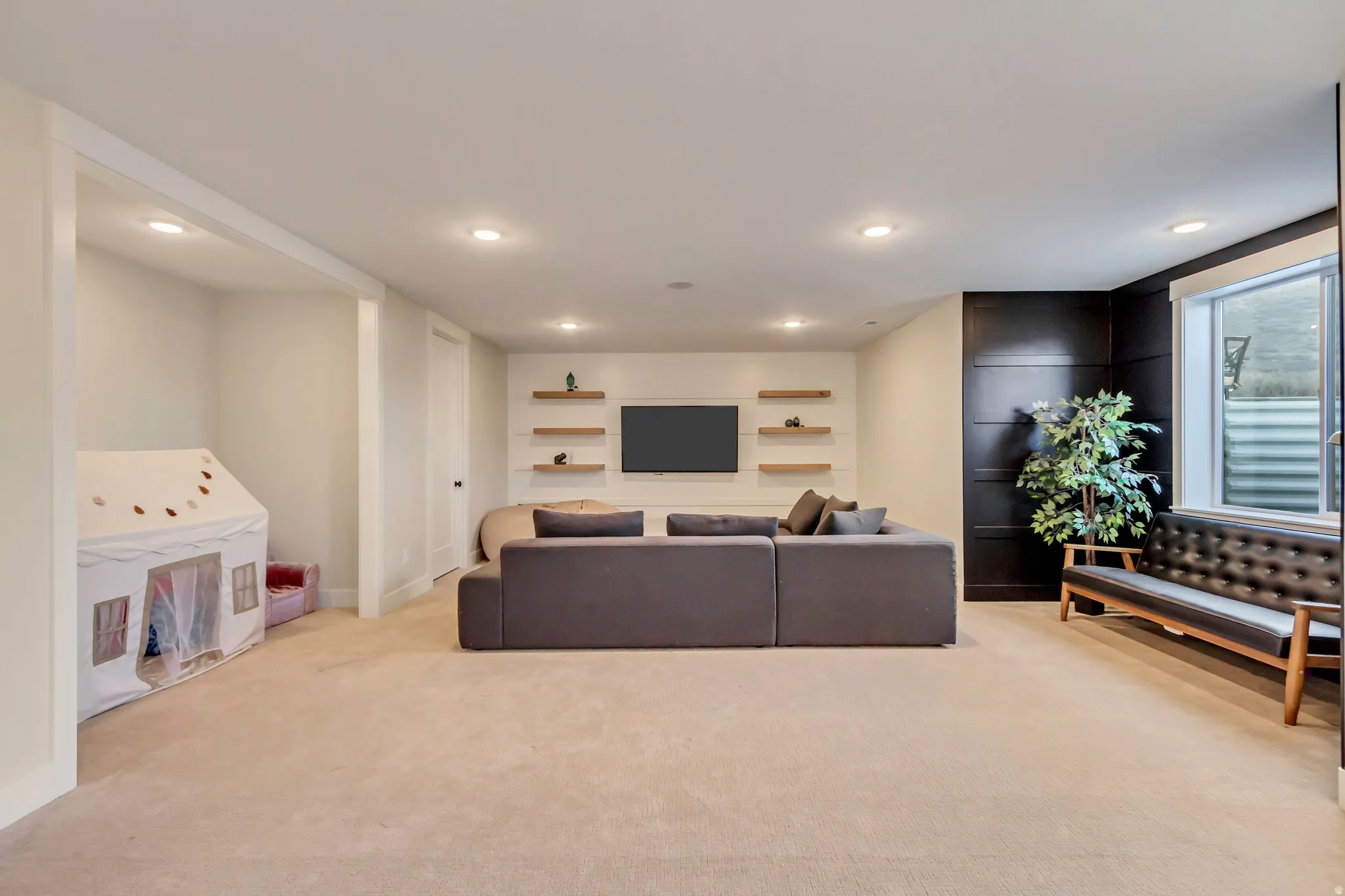 Living room featuring light colored carpet and recessed lighting