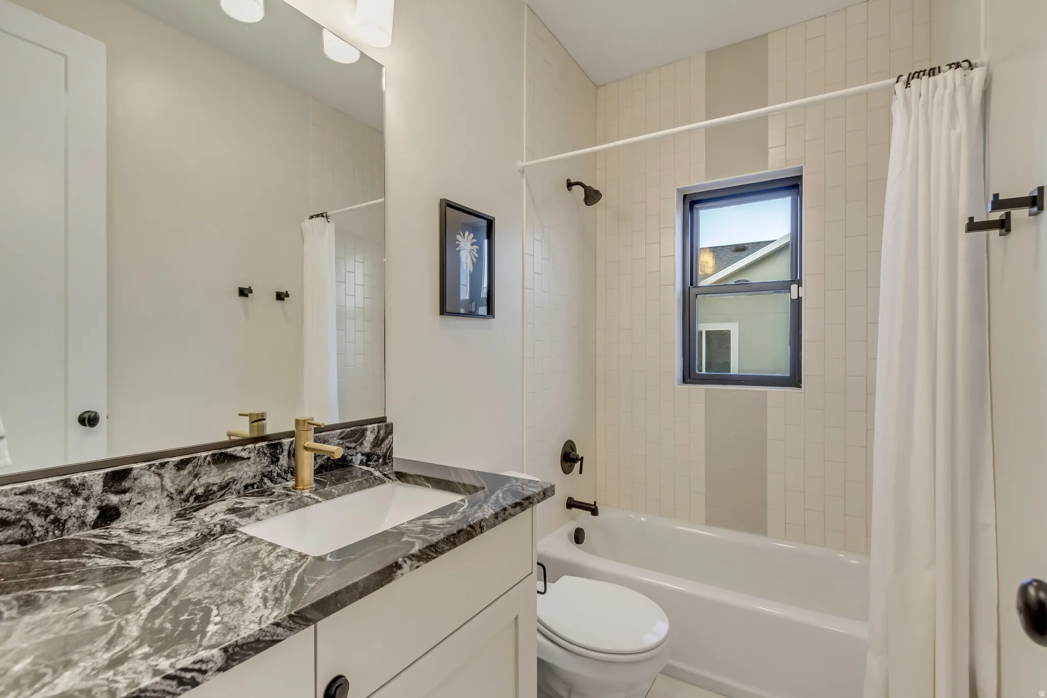 Bathroom featuring shower / bath combo and vanity
