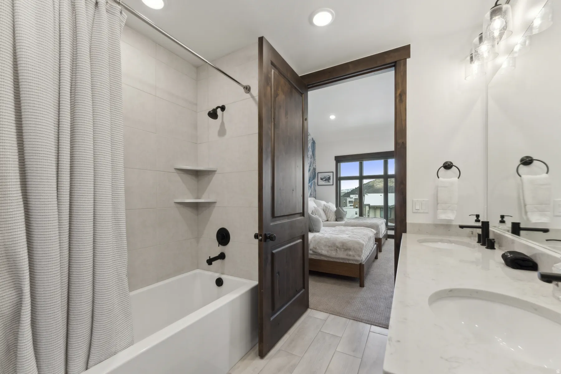 Full bathroom featuring shower / bath combo, ensuite bathroom, double vanity, and recessed lighting