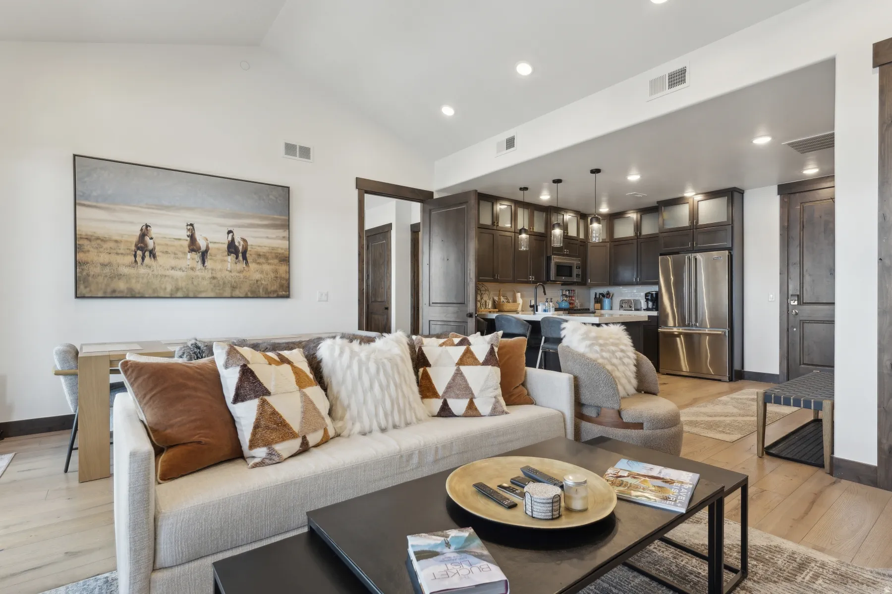 Living room featuring lofted ceiling, light wood-type flooring, and recessed lighting