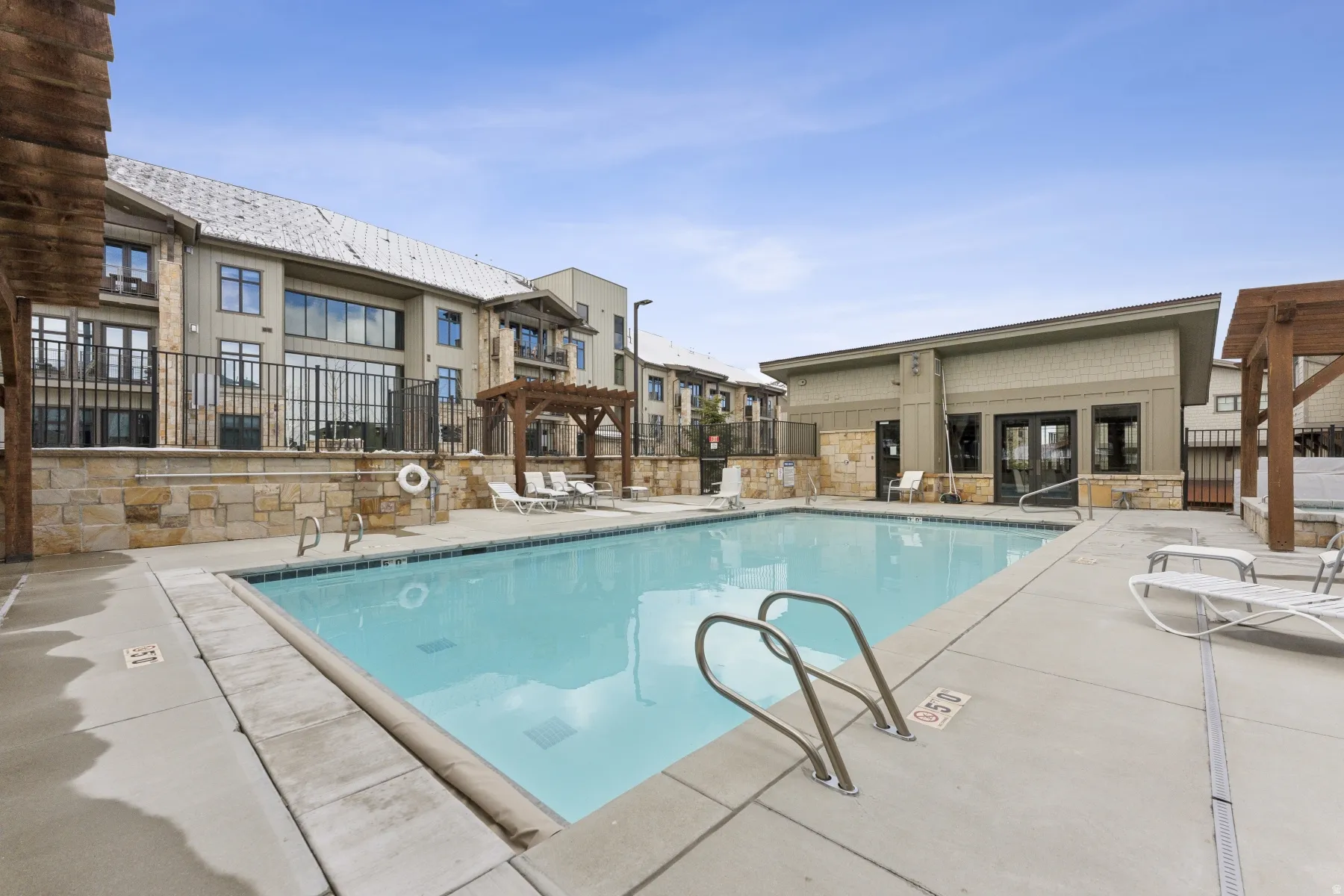 Community pool with a patio and a pergola