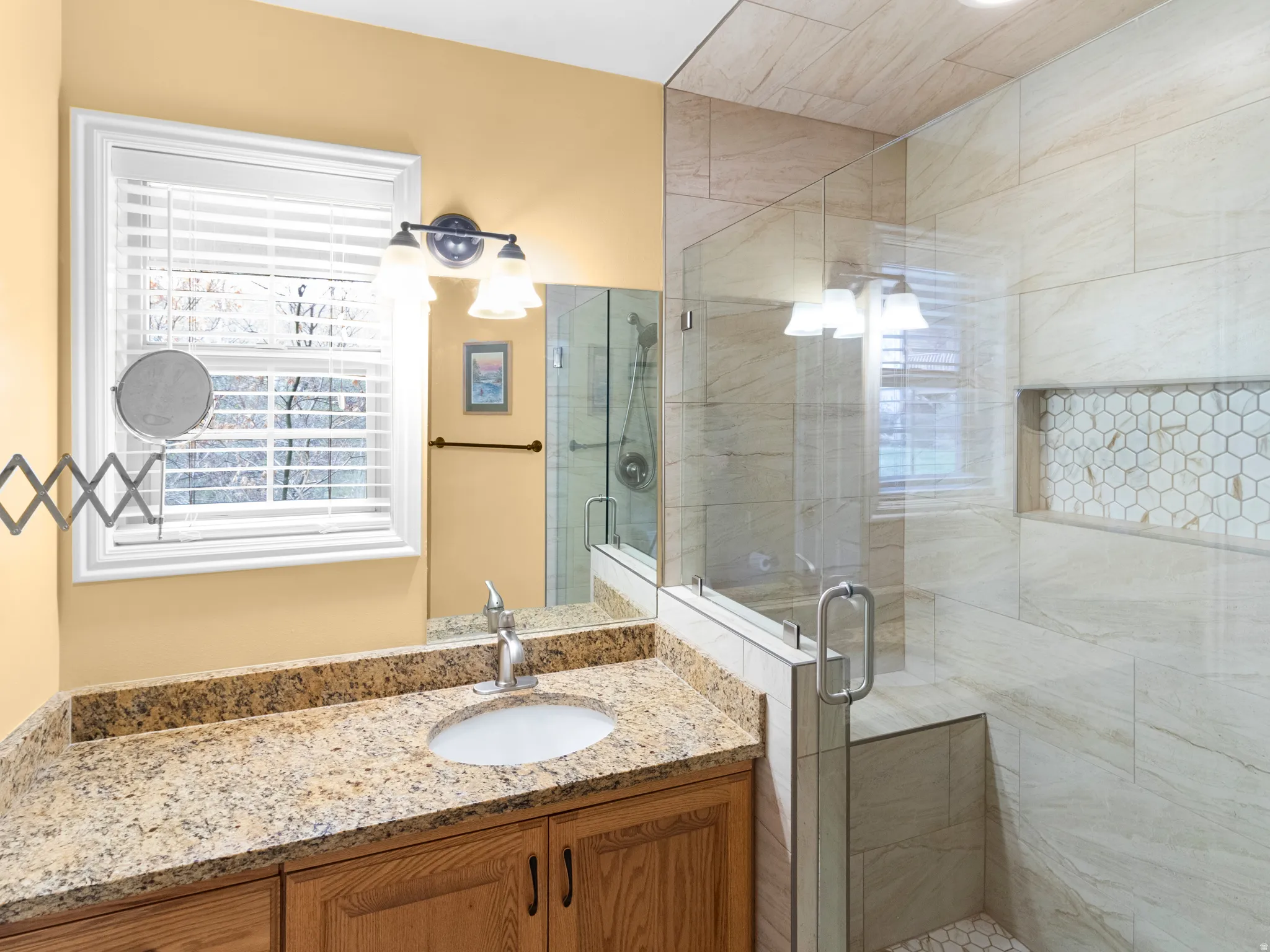Bathroom with a shower stall and vanity