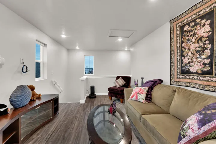 Living room featuring attic access, wood finished floors, and recessed lighting