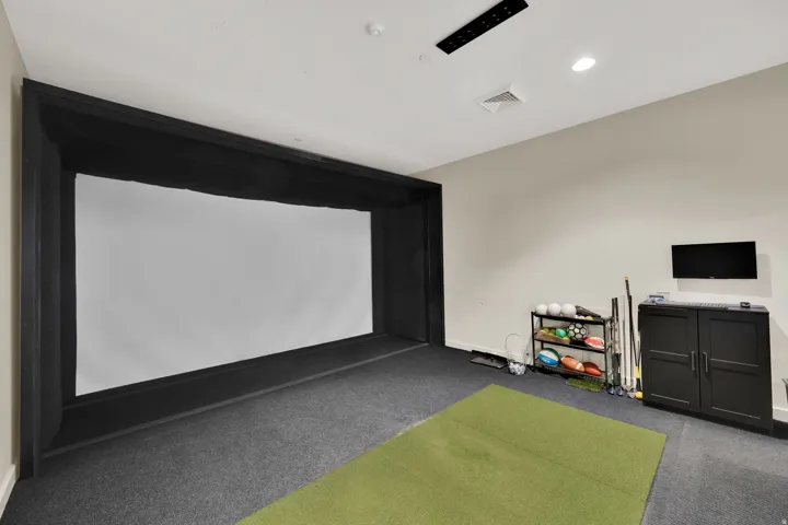 Recreation room with golf simulator, carpet floors, and recessed lighting