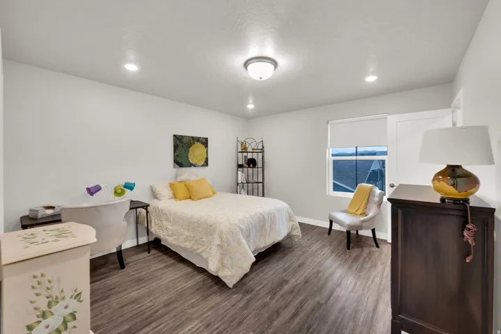 Bedroom featuring recessed lighting, dark wood-type flooring, and a textured ceiling