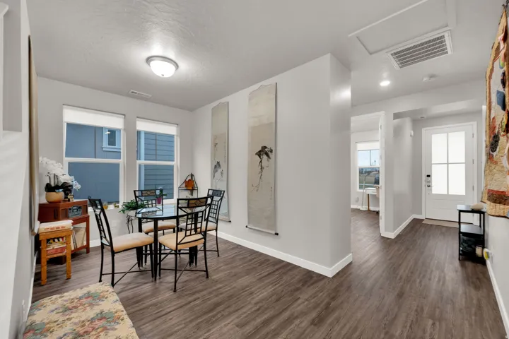 Dining area featuring dark wood-style flooring and a textured ceiling