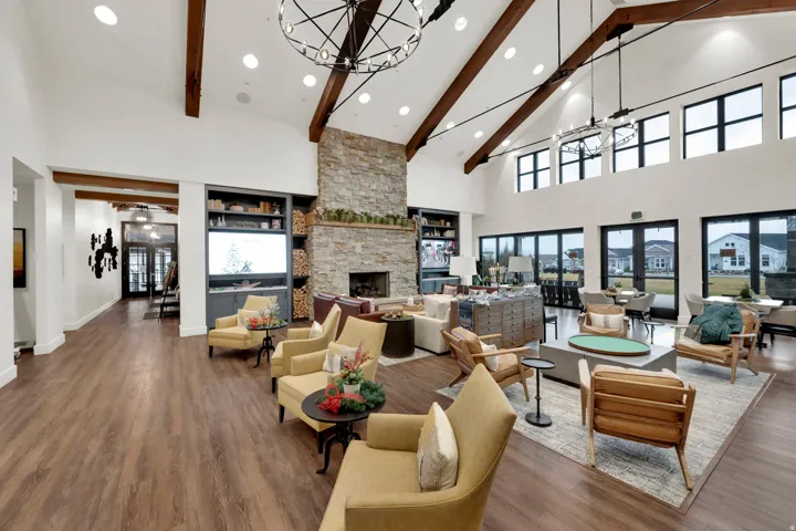 Living room with high vaulted ceiling, recessed lighting, a chandelier, beamed ceiling, and wood finished floors