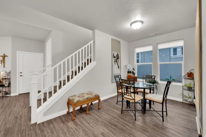 Dining room featuring stairs, wood finished floors, and a textured ceiling