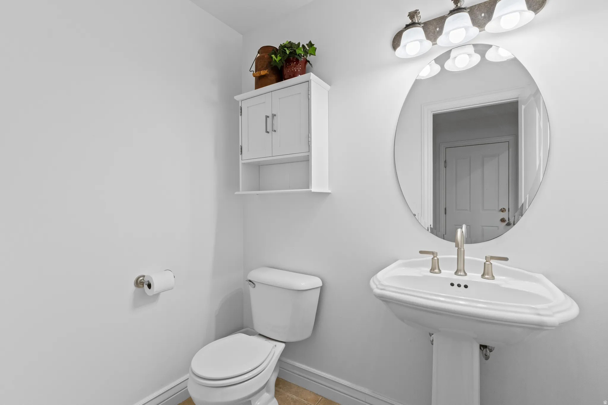 Half bathroom featuring toilet and light tile patterned floors