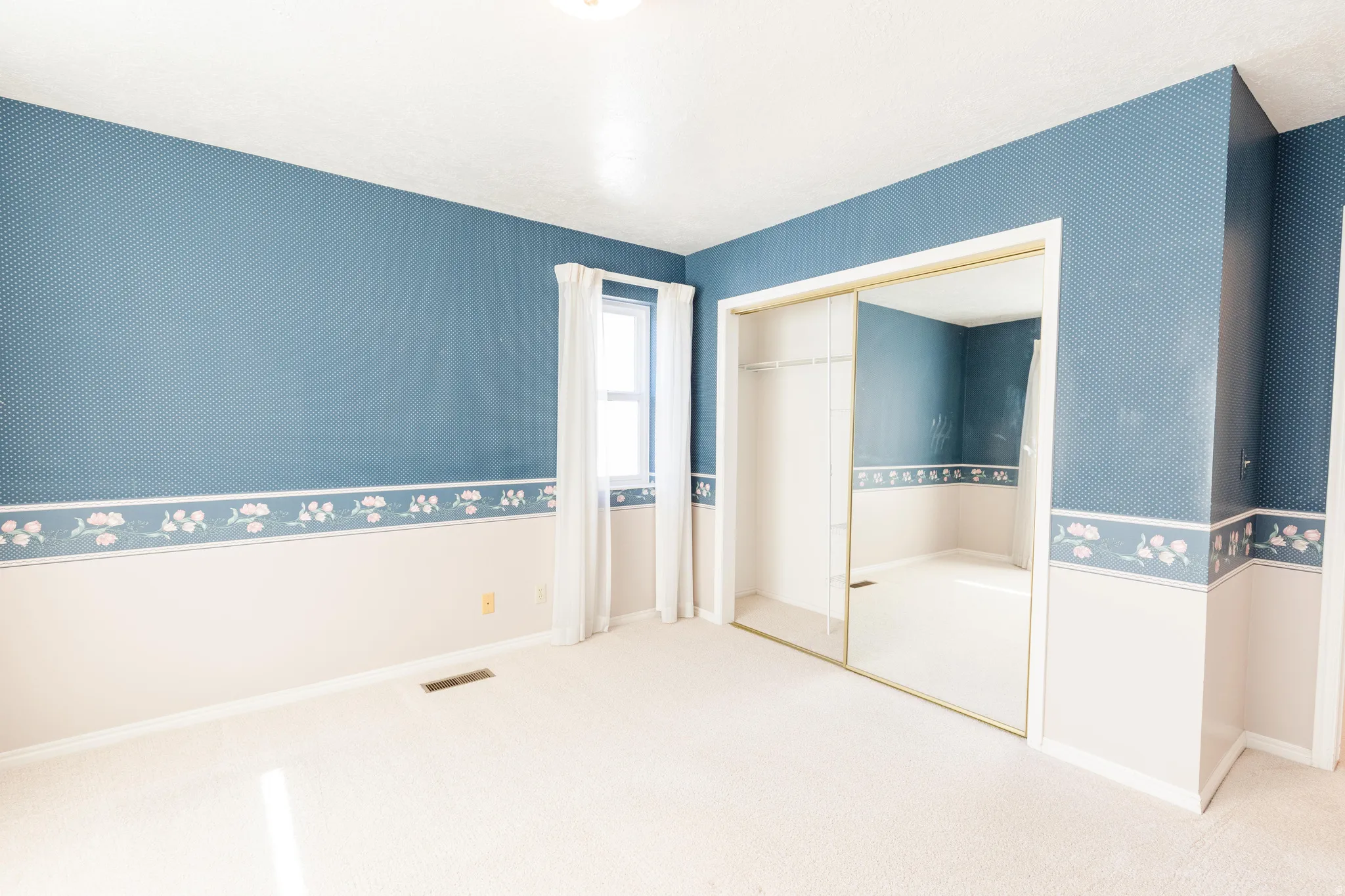 Unfurnished bedroom featuring carpet, a closet, and wallpapered walls