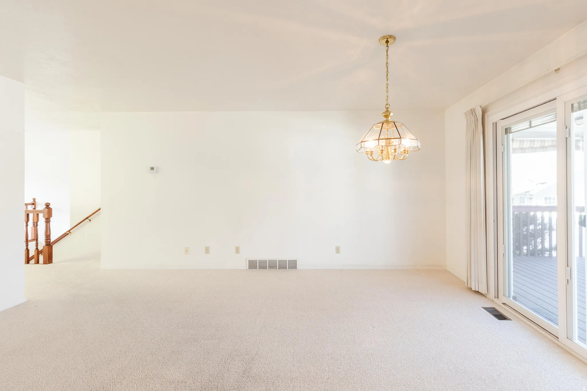 Unfurnished room with carpet flooring and a chandelier